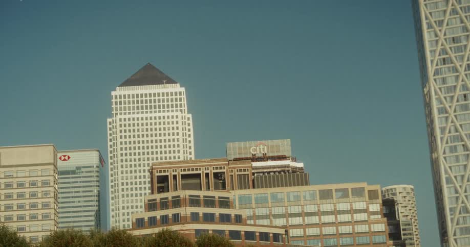 A citys financial district skyline showcasing various highrise corporate buildings under a clear blue sky
