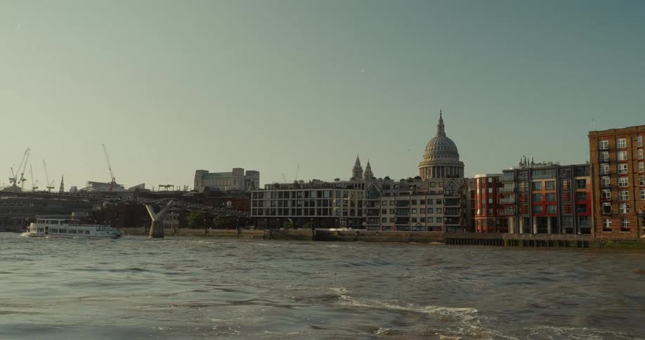 Dome of st pauls cathedral seen from the river thames under a clear sky