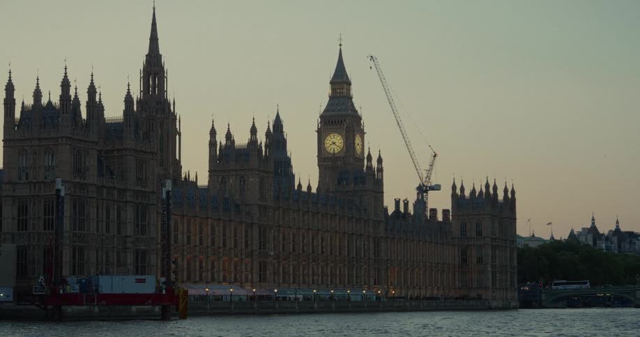 Palace of westminster with big ben in the background at sunset