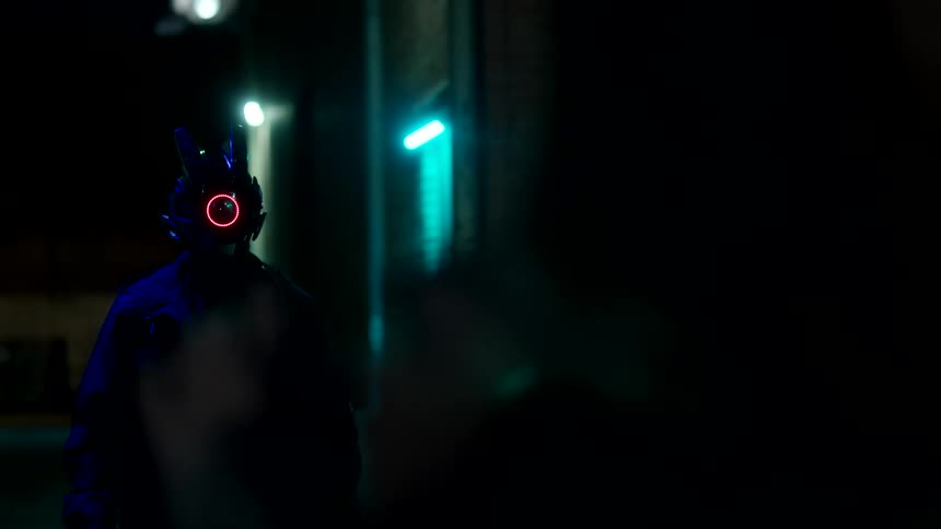 A person in headgear approaches another person