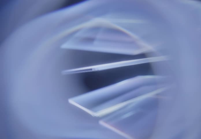 Some rectangular objects of transparent blue colors are rotating slowly