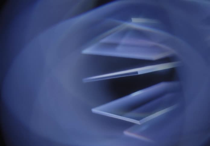 Abstract glass like shapes in blue with smooth curves and light reflections