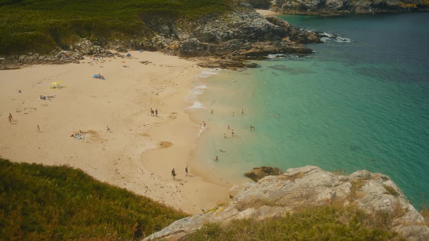 Aerial of a group of people having fun outdoors at a beach during daytime