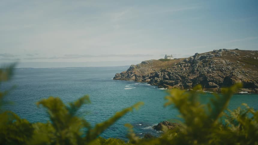 Lonely house located on top of a rocky cliff by the sea