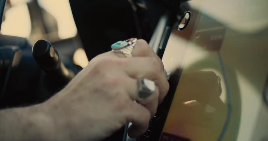 The video shows the interior of a car focusing on the center console and the steering wheel on the left side of the vehicle sunlight is streaming through the car windows creating a bright and airy atmosphere