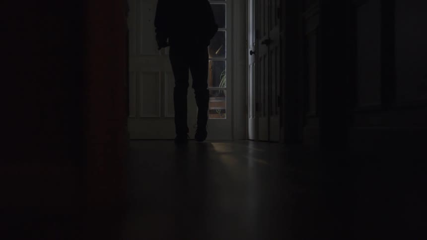 Person sneaking into house at night