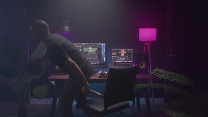 The man gets up from his desk and walks away