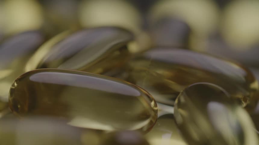 Golden transparent capsules clustered in closeup