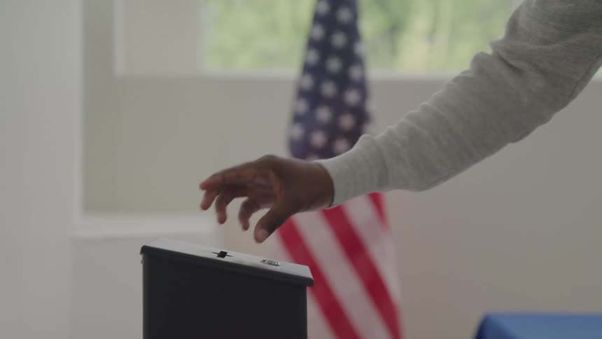 The man places his vote in the black box