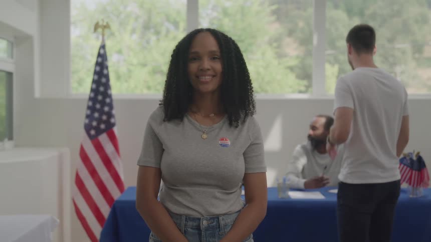 A woman is smiling in the voting center