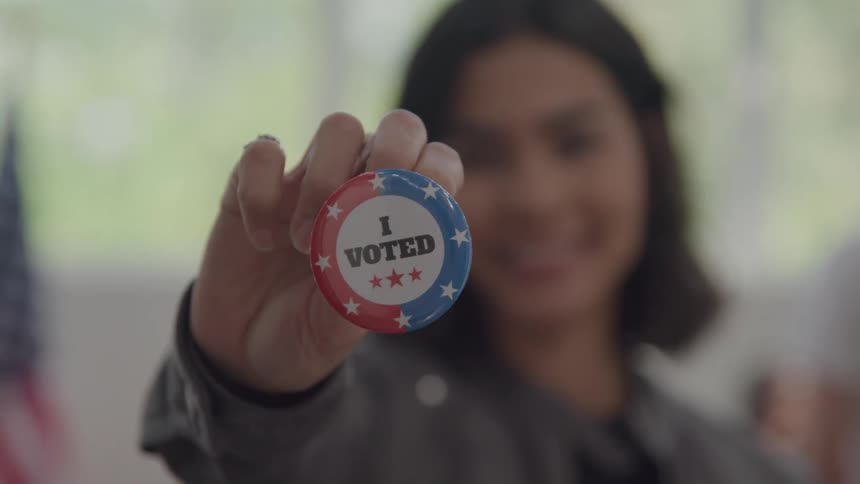 The woman is showing off a button