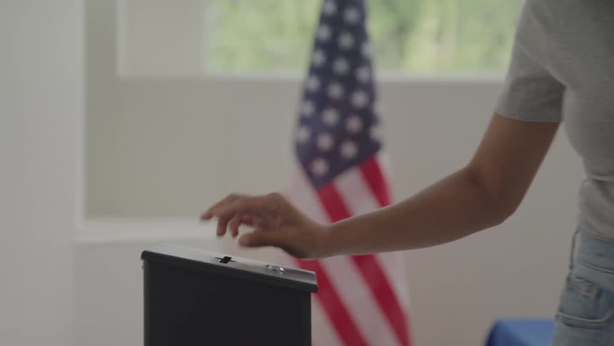 The woman casts her ballot