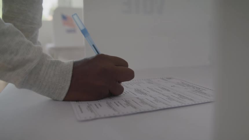 The man fills out the form