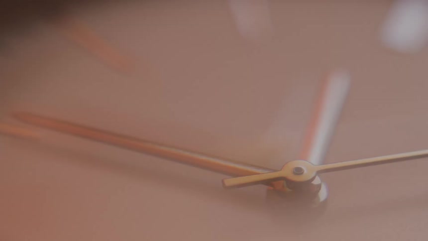 The hands of a watch spin extremely fast during a time lapse of the watch face