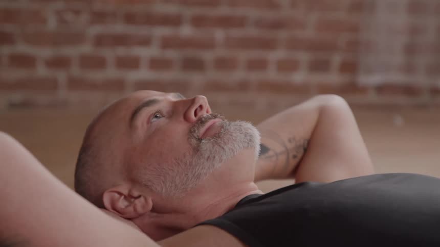 The man is working out on the floor