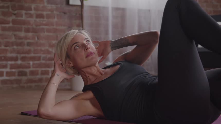The woman is working out at home