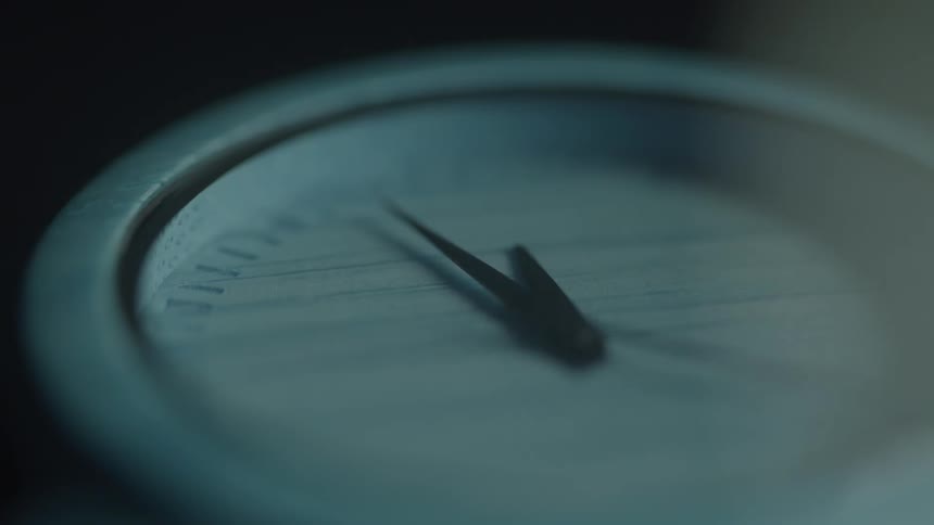Extreme close up of a working blue analogue watch dial