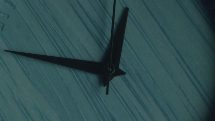 A timelapse captures the fastmoving hands of an analog clock with a blue textured face symbolizing the rapid passage of time