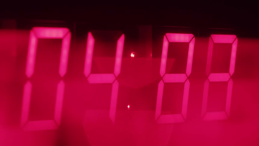 A closeup of a red digital timer shows the numbers rapidly counting down from ten seconds to zero