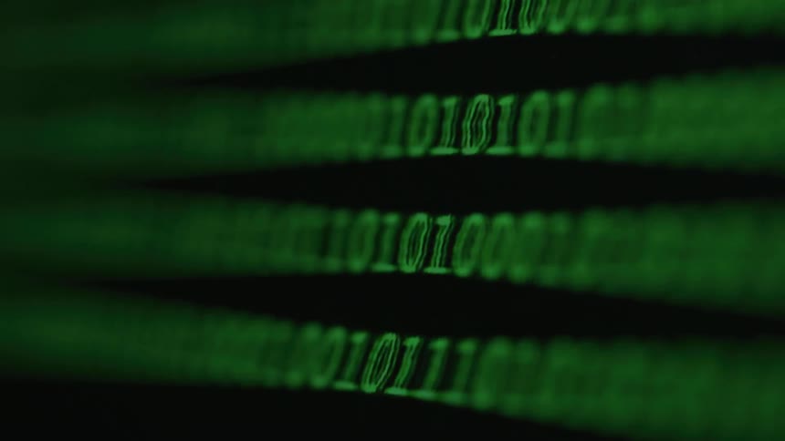 Thin horizontal green numbers and letters on a dark background in a blurry motion