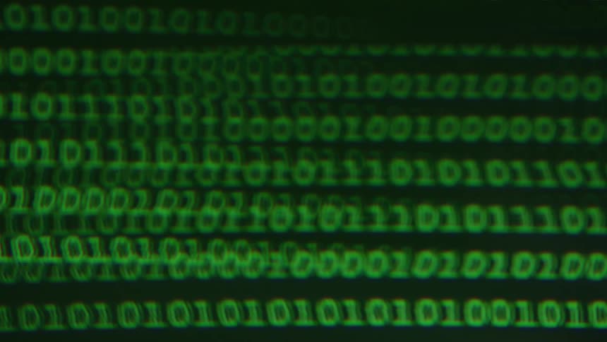 The video shows two horizontal lines of green binary code appearing on a dark screen the lines are composed of numbers 0 and 1 and more code seems to be appearing and moving down from the top