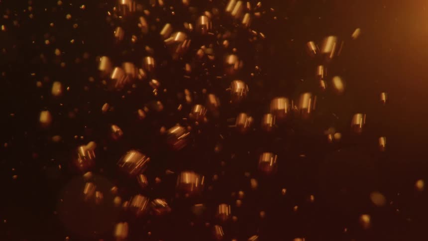 In an extreme closeup a chaotic flurry of goldenbrown bubbles rapidly rises and fizzes through a dark carbonated beverage like cola or beer