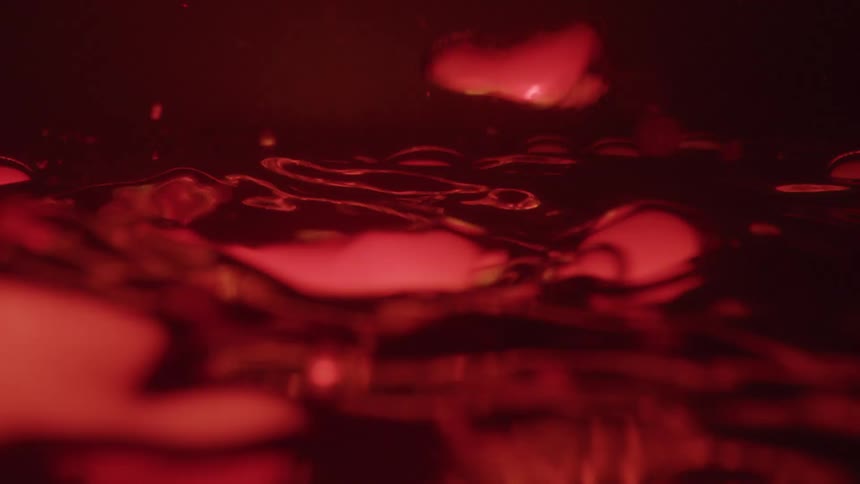 Red liquid ripples in a moody cinematic closeup