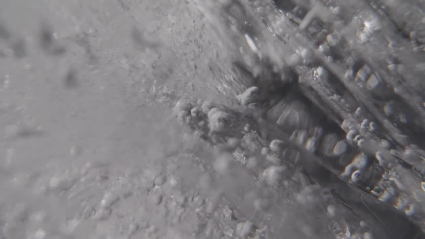 Bubbles forming in boiling water seen in closeup