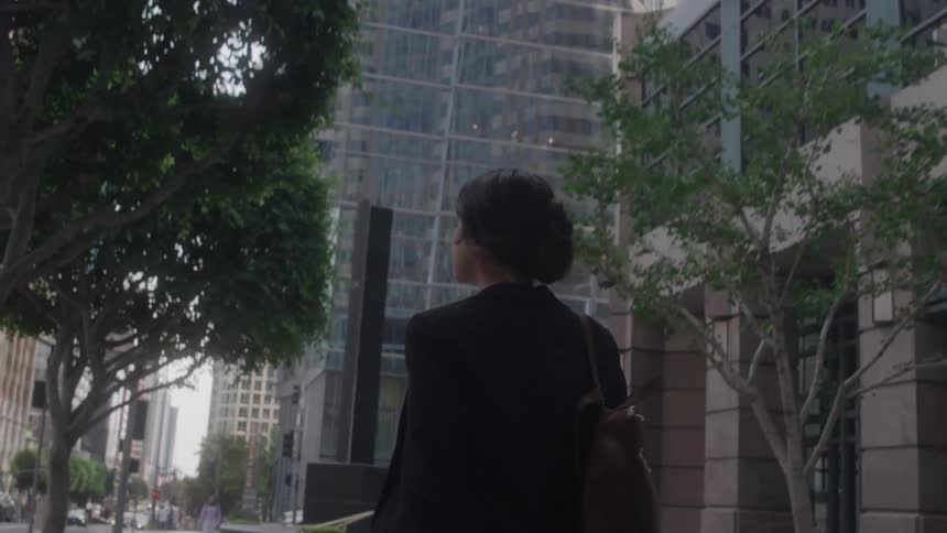 The woman walks through the city