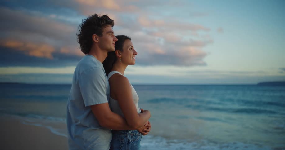The couple are hugging on the beach
