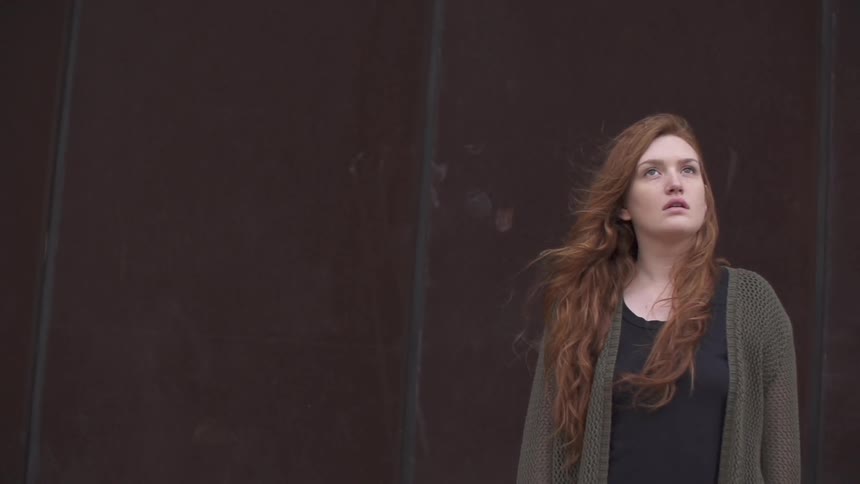 Woman standing and looking towards the sky
