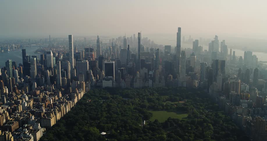 An aerial view captures the sprawling cityscape of new york with central park nestled amongst the towering skyscrapers