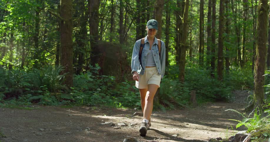 The woman hikes down the trail