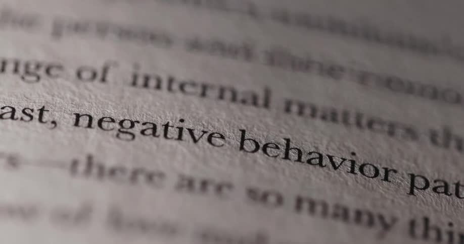 Closeup of a book page with negative behavior patterns in sharp focus