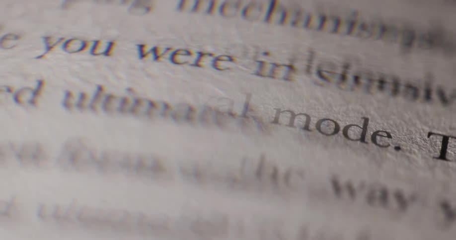 The camera focuses on a page of a book the words in survival mode are clearly visible while the rest of the text is slightly out of focus