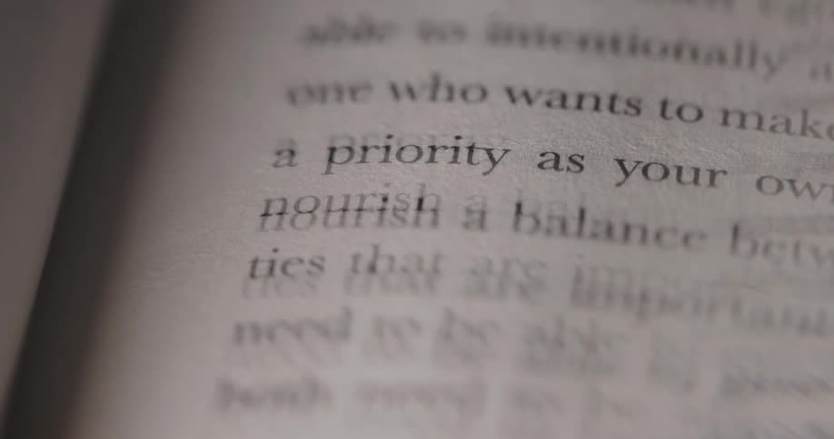 The camera is focused on a page of a book the words nourish a balance are clearly visible while the rest of the text is slightly out of focus
