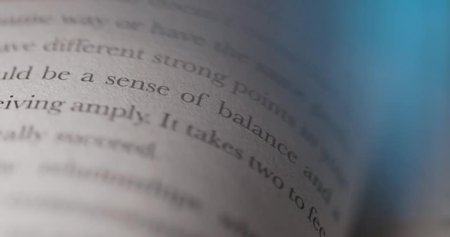 Blue colored light passes over the pages of an open book
