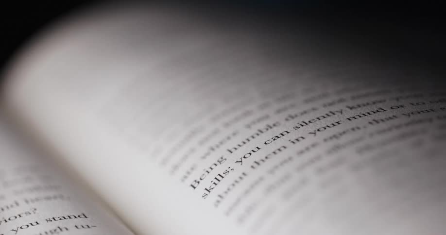 The video shows two closeup shots of a book the first shot shows the phrase on selfawareness with the sentence humility is a necessary character the second shot starting around the threesecond mark shows the text being humble does not mean