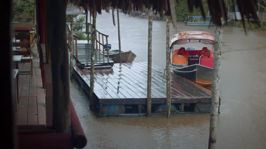 The boat is anchored by the pier