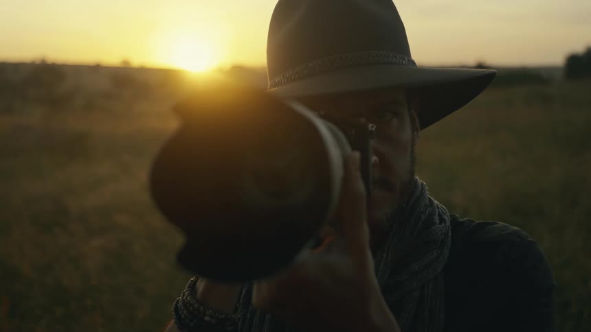 The man takes a photo with a long lens camera