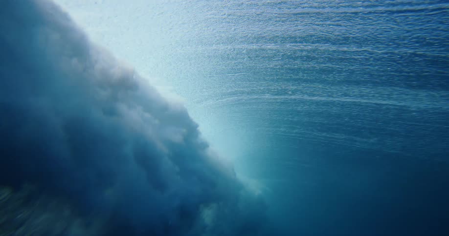 The wave rolls underwater when it crashes
