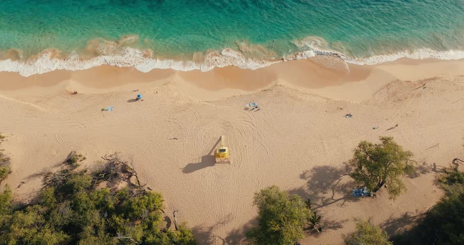 People walk in the sand on the beach