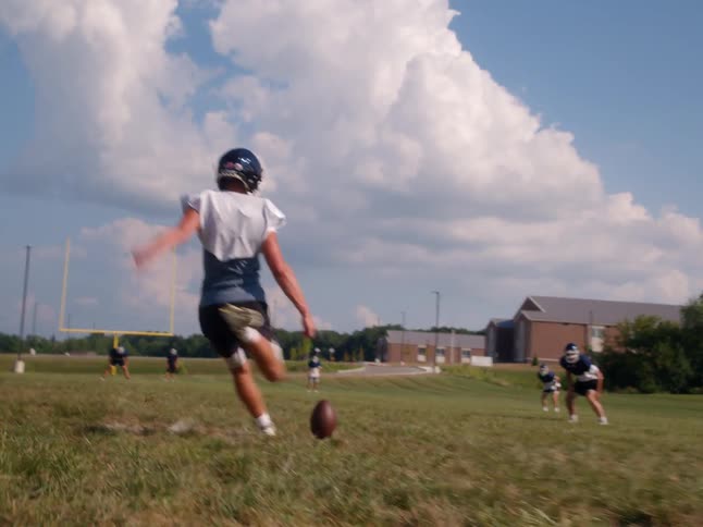 American football player prepares for kickoff on an open field