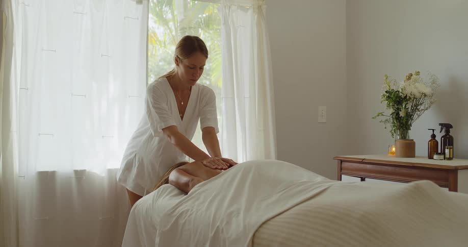 Massage session in a room lit by natural light
