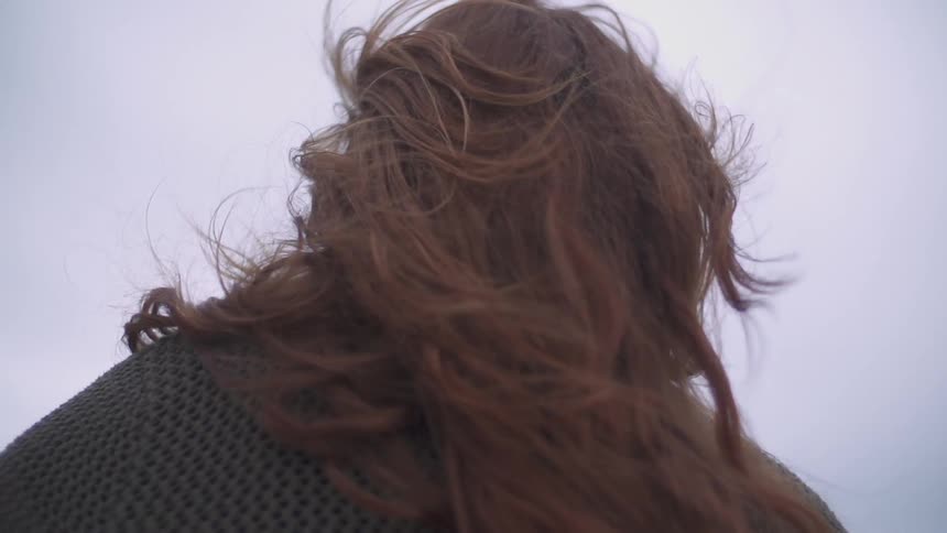 The wind blows a woman's long hair