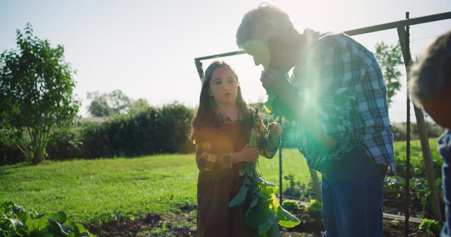 The woman tastes a vegetable on the farm
