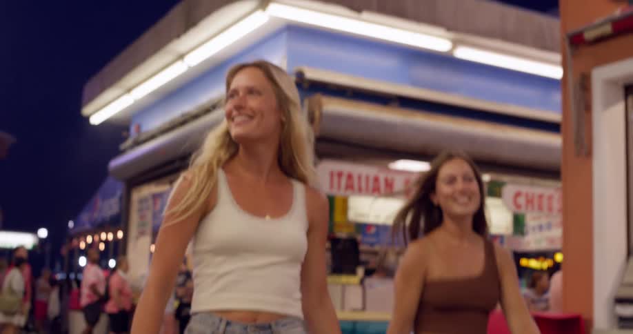 Night stroll along the boardwalk with illuminated food stands
