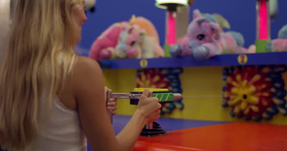 Two women are playing a carnival game together