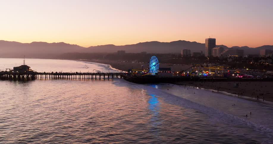 The amusement park rides are brightly lit on the shore