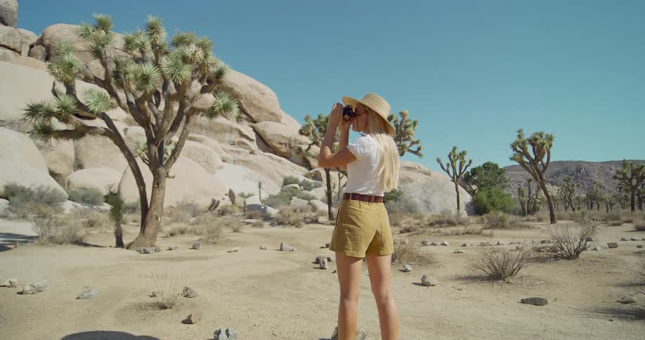 The woman is talking pictures of the canyon